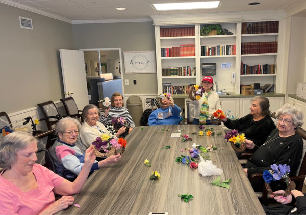 Large group of senior women make flower crafts together in Lambertville, Michigan