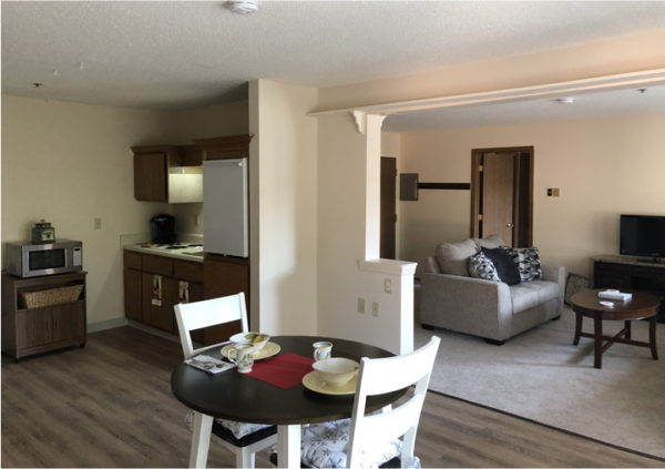 Model apartment with living room, kitchenette and dining area in East Lansing, Michigan.