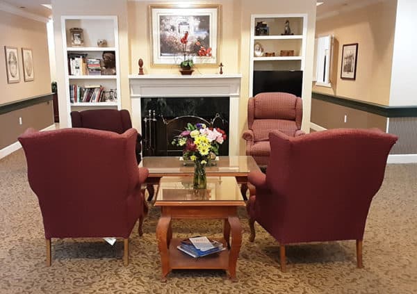 A beautiful lounge area with comfortable seating and a fireplace in Hamilton, Ohio.