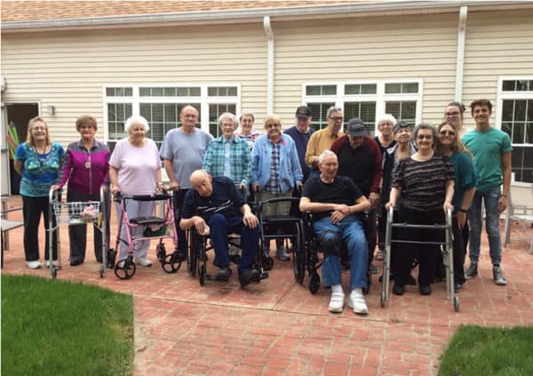 A group of residents and staff gathered outside at Keystone Woods in Anderson, Indiana.