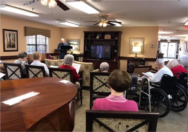 Seniors enjoying a guest speaker at their retirement home in Anderson, South Carolina.