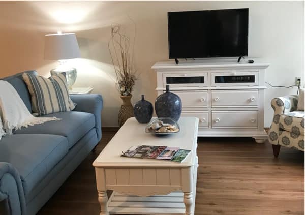 A model apartment living room with stylish furniture and a big-screen TV in Raleigh, North Carolina.