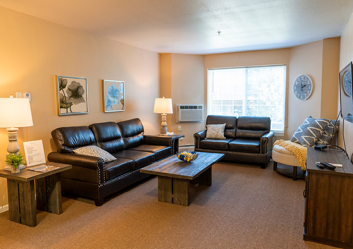 The living room of an independent living apartment with couches in Maple Grove, Minnesota.