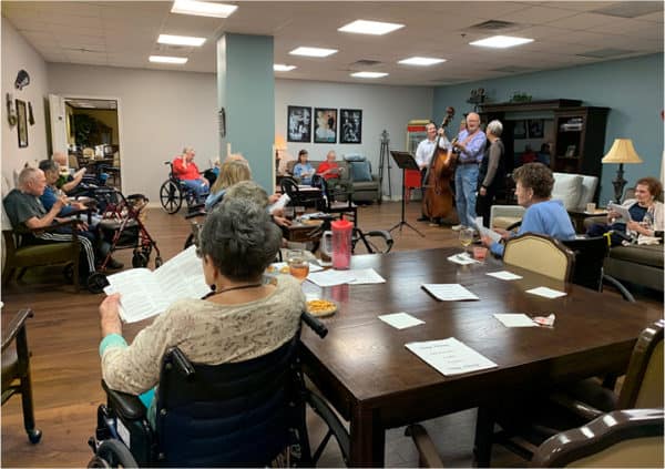A sing-along at a retirement home with residents sitting in chairs in Humble, Texas.
