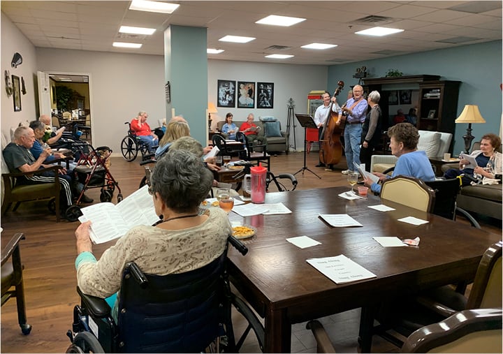 A sing-along at a retirement home with residents sitting in chairs in Humble, Texas.
