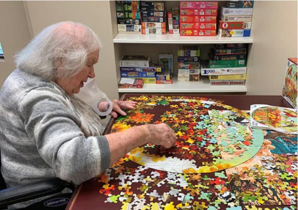 A resident working on a puzzle in the activity center in Humble, Texas.