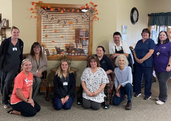 Ten senior living employees pose together for a group shot