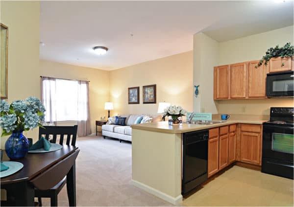 A senior living apartment with a kitchen and inviting living room in Macedonia, Ohio.