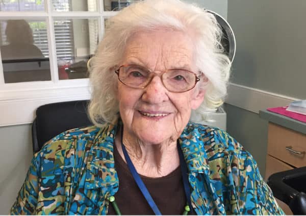 A smiling resident at senior living facility in Anderson, South Carolina enjoys her new hairstyle.