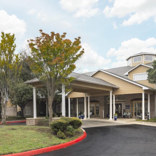 Front entrance to a senior living facility in San Antonio, Texas with a circular driveway