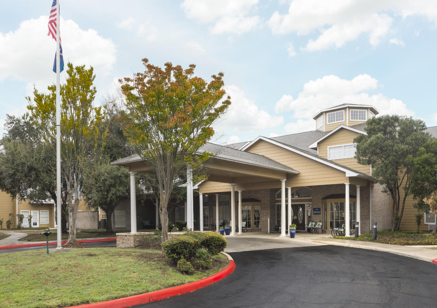 Front entrance to a senior living facility in San Antonio, Texas with a circular driveway