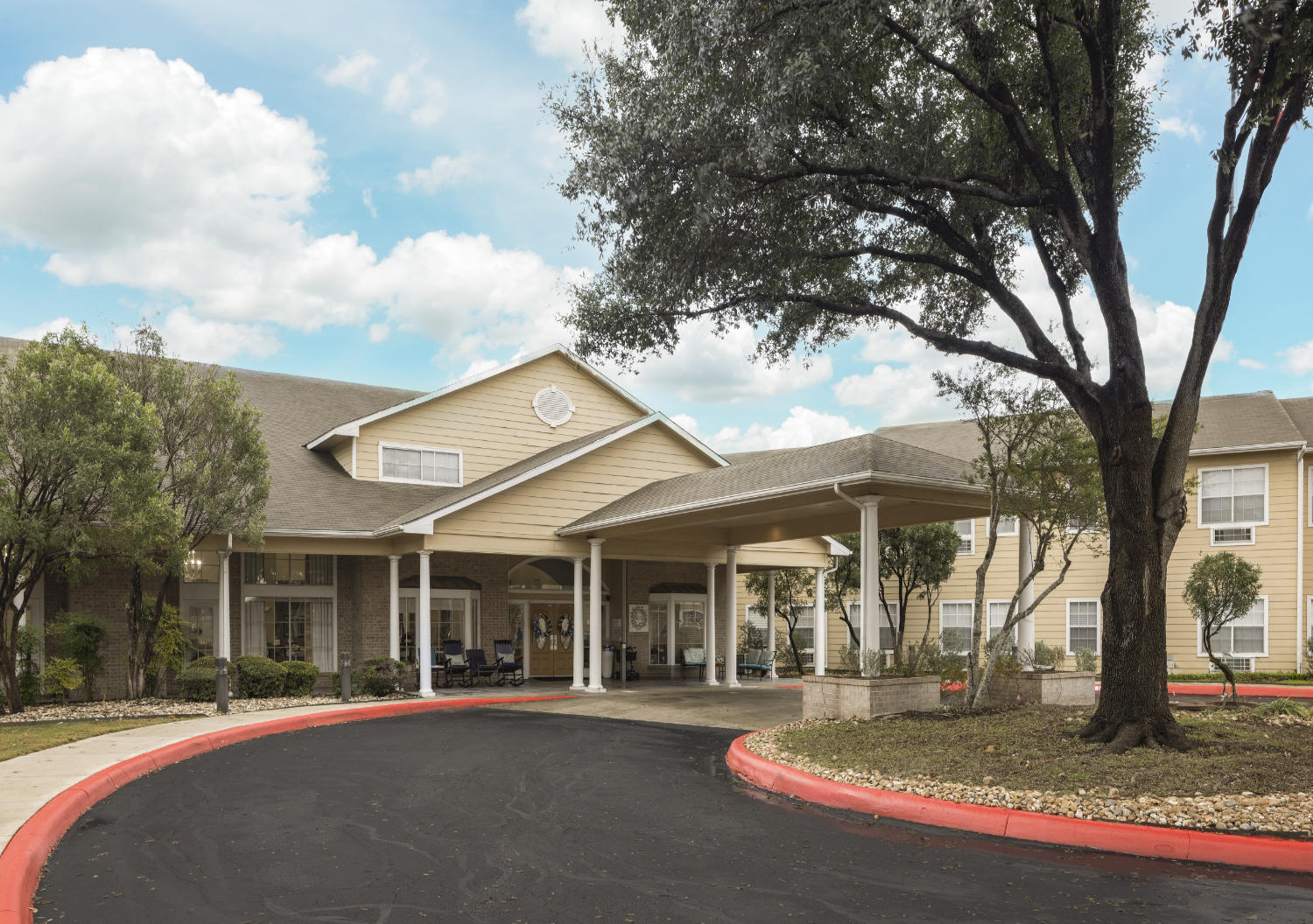 Front entrance to The Waterford at Thousand Oaks senior living community with a circular driveway in San Antonio, Texas