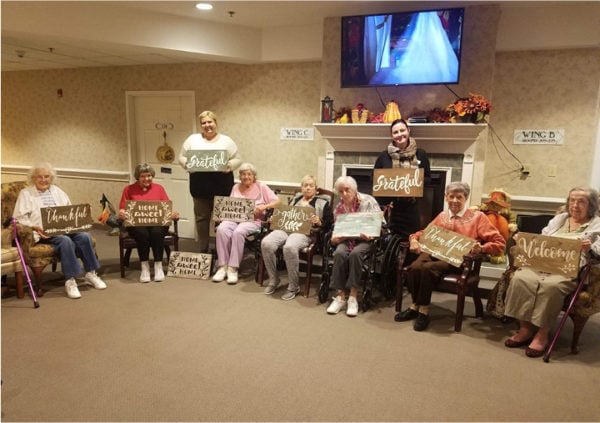 A group of seniors smiling and showing off their completed craft in Columbiana, Ohio.