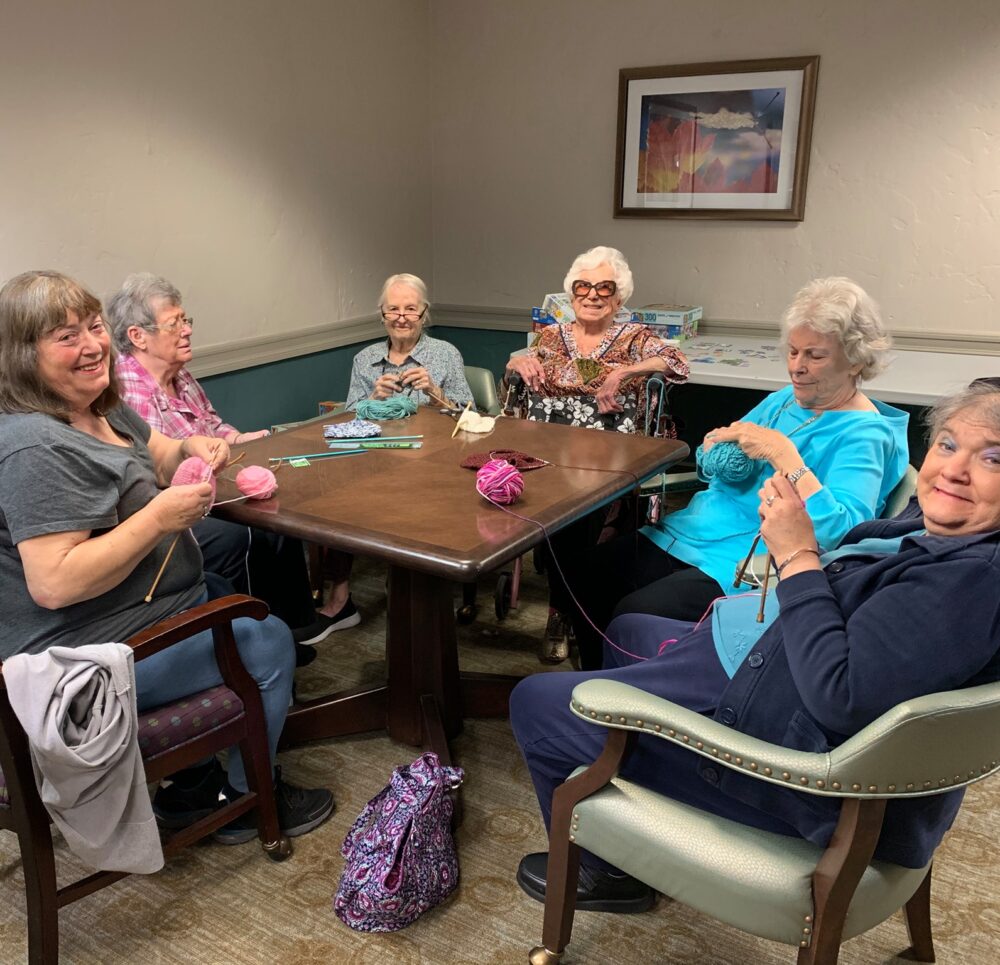 group of senior women knit together at Villa Santa Barbara senior living