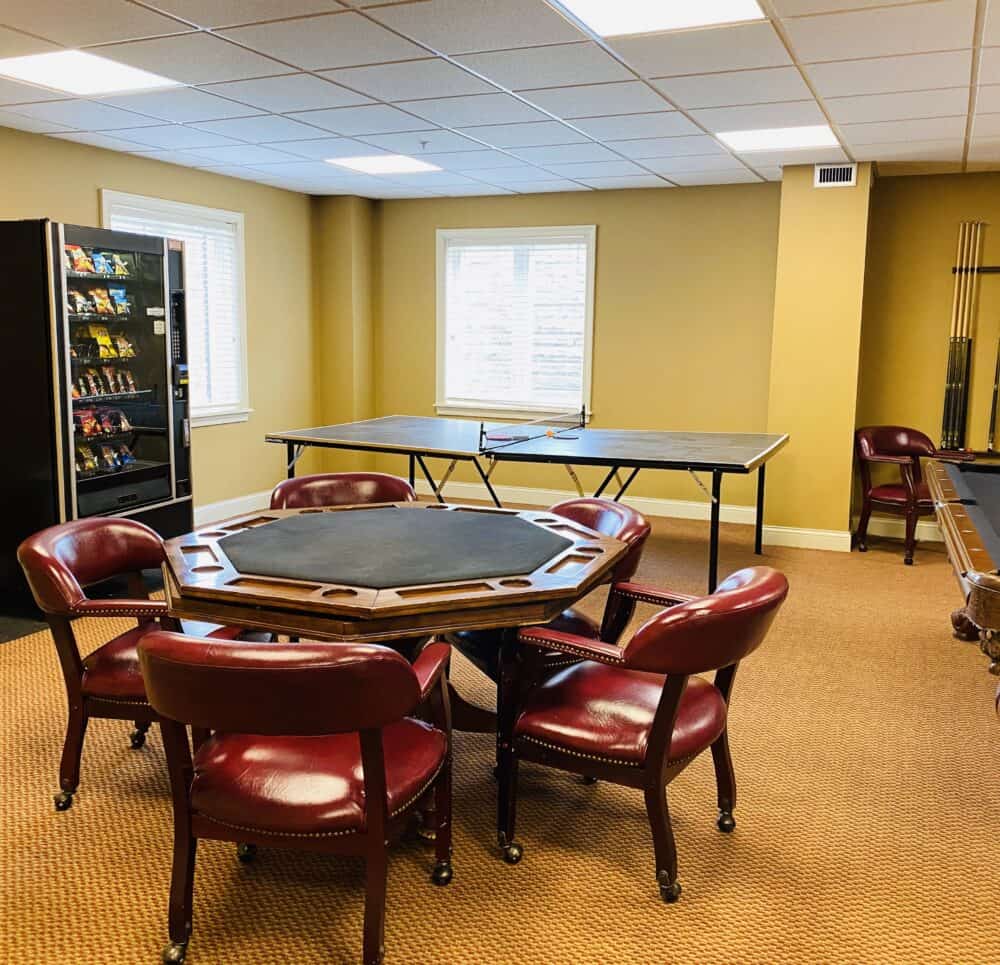 Activity room with table and pool table and ping pong at senior living community in Cincinnati, Ohio.