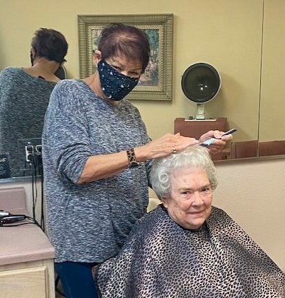 On-site salon with a senior man inside at senior living facility in North Richland Hills, Texas.