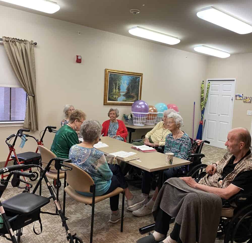 Group of seniors during a bible study session at senior living facility in Granbury, Texas.