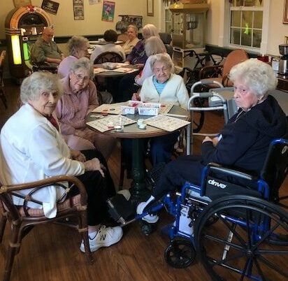 Senior ladies playing bingo in the ice cream parlor at a senior living community in Hamilton, Ohio.