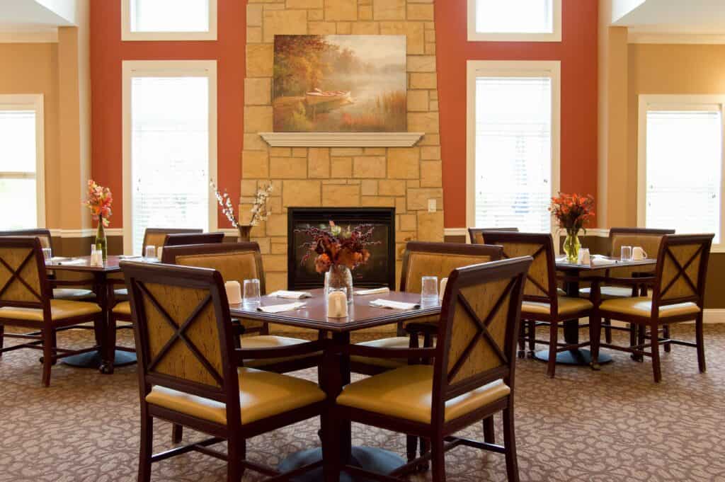 Dining room at the Waterford at Fitchburg, a senior community in Fitchburg, Wisconsin with lots of natural light and many tables..