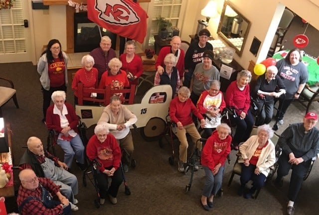 Large group of seniors cheering on the Kansas City Chiefs football team at Vintage Gardens, a senior living community in St. Joseph, Missouri.