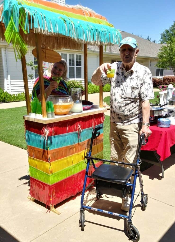 Senior man getting a drink outside at Whitley Place in Keller, Texas.