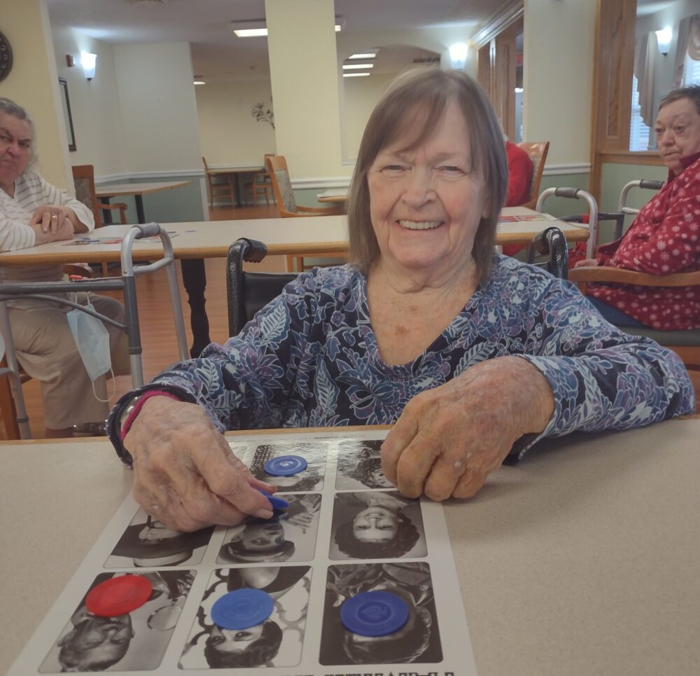 Senior woman plays famous-person Bingo at a senior living community in Jeffersonville, Indiana.