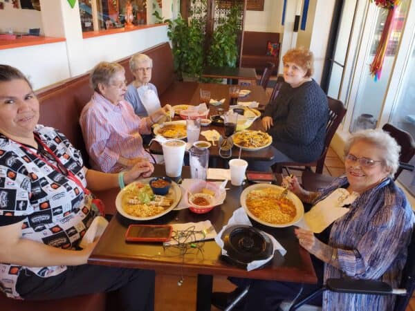 Group of seniors eat together during lunch at a senior living community in San Antonio, Texas.