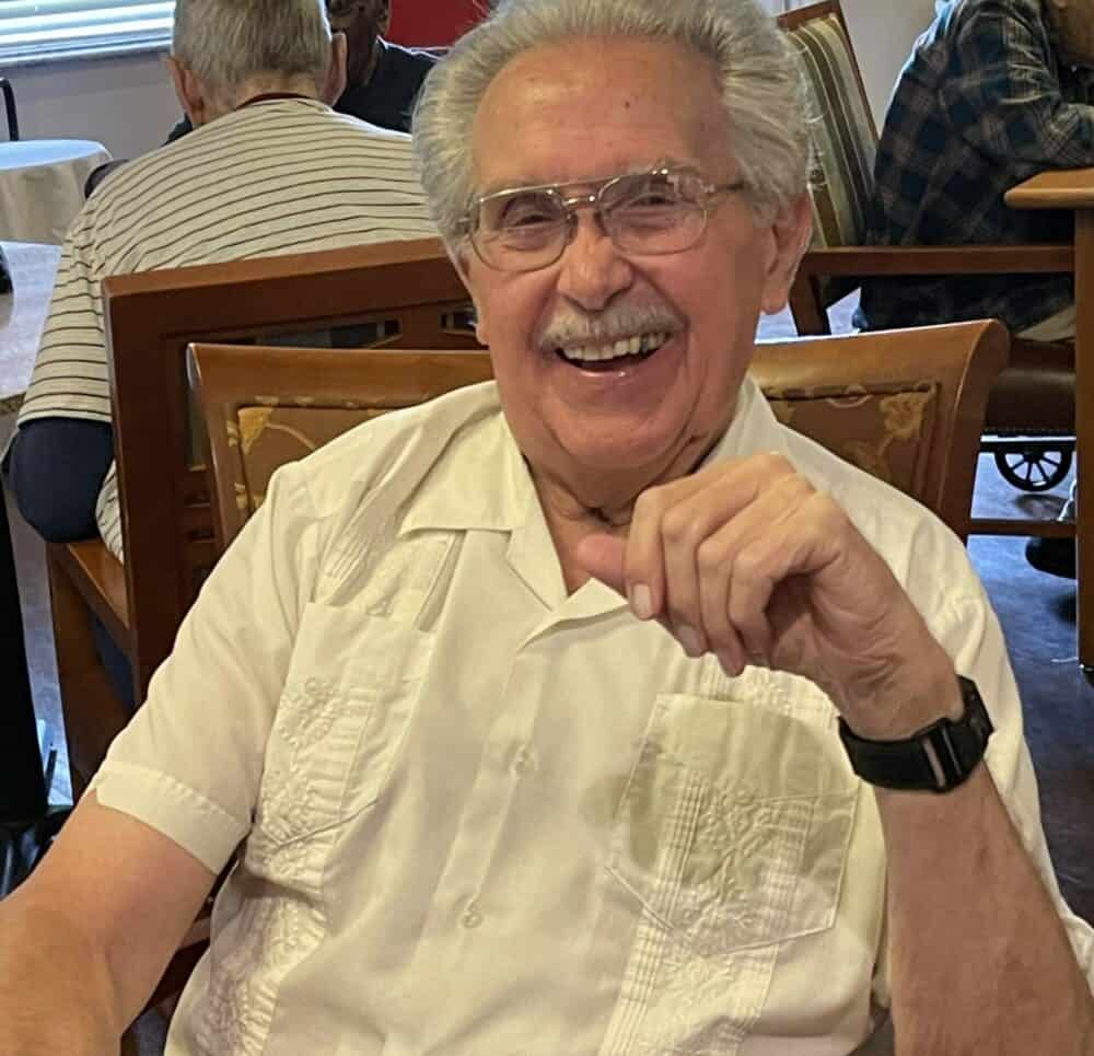 Senior man smiles at the camera at a memory care community in Pensacola, Florida.