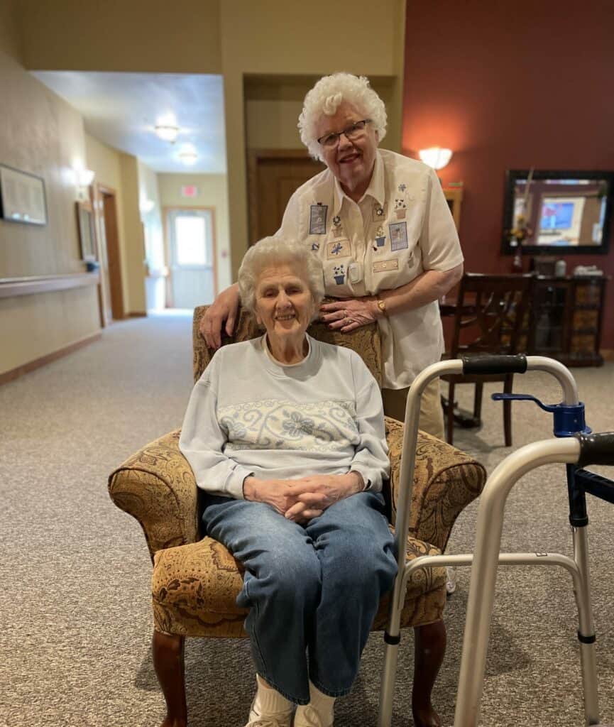 Two senior women smile at the camera while at a senior living community located in Park Falls, Wisconsin.
