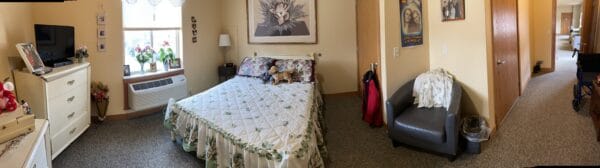 Bedroom with bed, dresser and TV at a senior living community in Park Falls, Wisconsin.