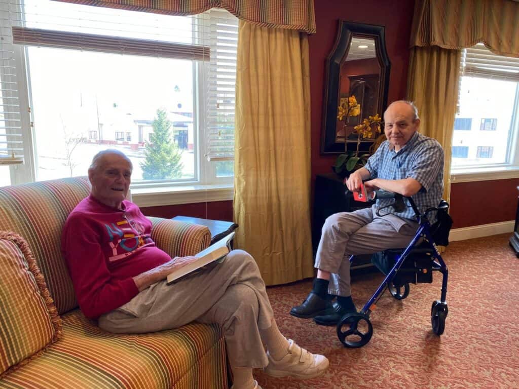 Two senior men sitting together at senior living community in Cincinnati, Ohio.