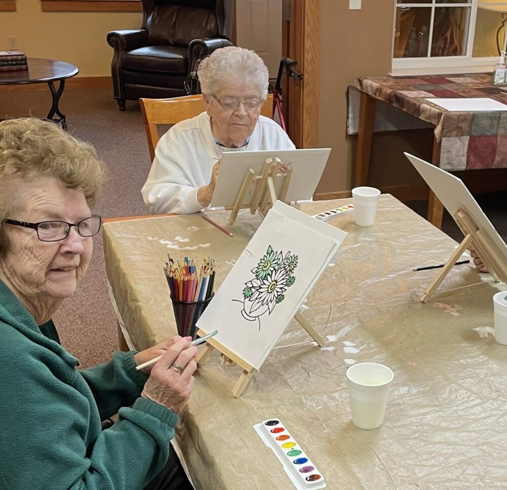 two senior women participate in a painting class