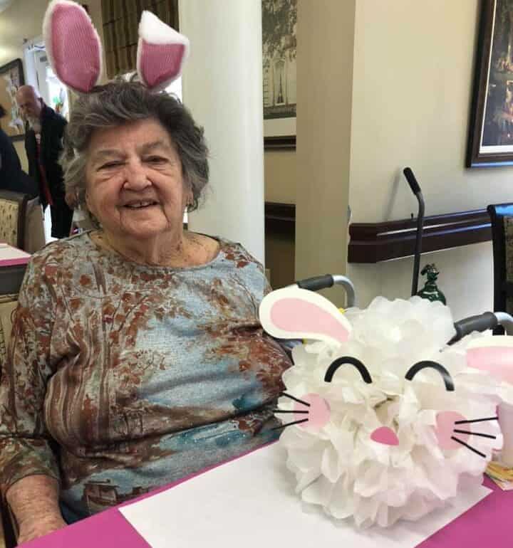 Senior woman poses with Easter decorations at senior living community in Anderson, South Carolina.