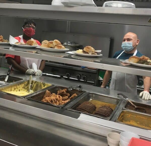 Two employees working in the kitchen at a senior living community in Fort Worth, Texas.