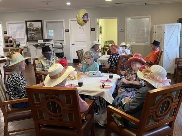 Group of seniors celebrate the Kentucky Derby at a memory care community in Pensacola, Florida.