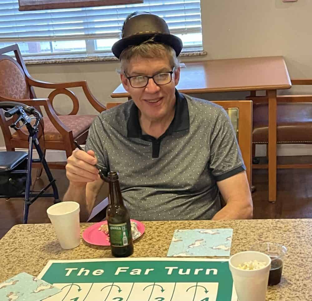 Senior man plays a game at a memory care community in Pensacola, Florida.