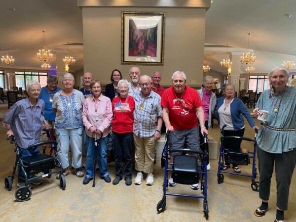 Groups of seniors take a group shot while participating in Olympics-themed games at a senior living community in East Lansing, Michigan.