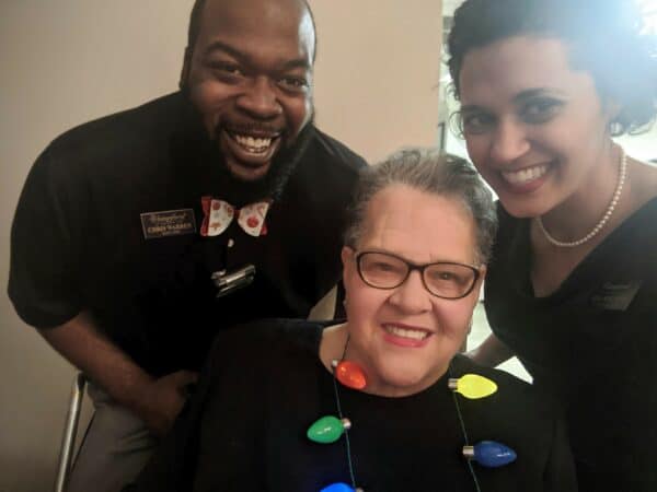 Three individuals smiling for a selfie at a senior living facility in San Antonio, Texas.