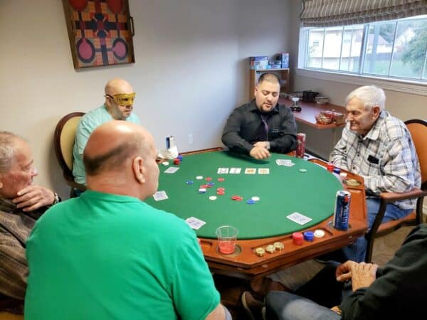 Group of senior men playing poker at a senior living facility in San Antonio, Texas.