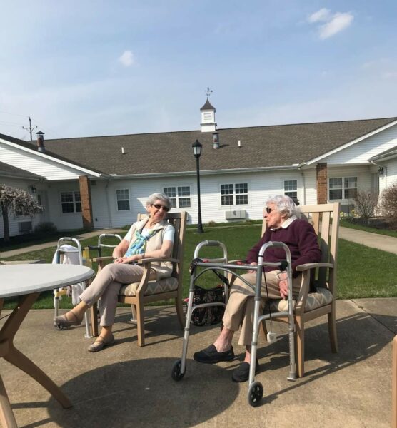 Two ladies chatting outside a senior living community in Chardon, Ohio.
