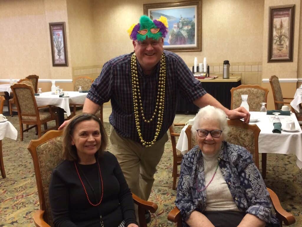 Three seniors celebrate Mardi Gras at a senior community in Perrysburg, Ohio.