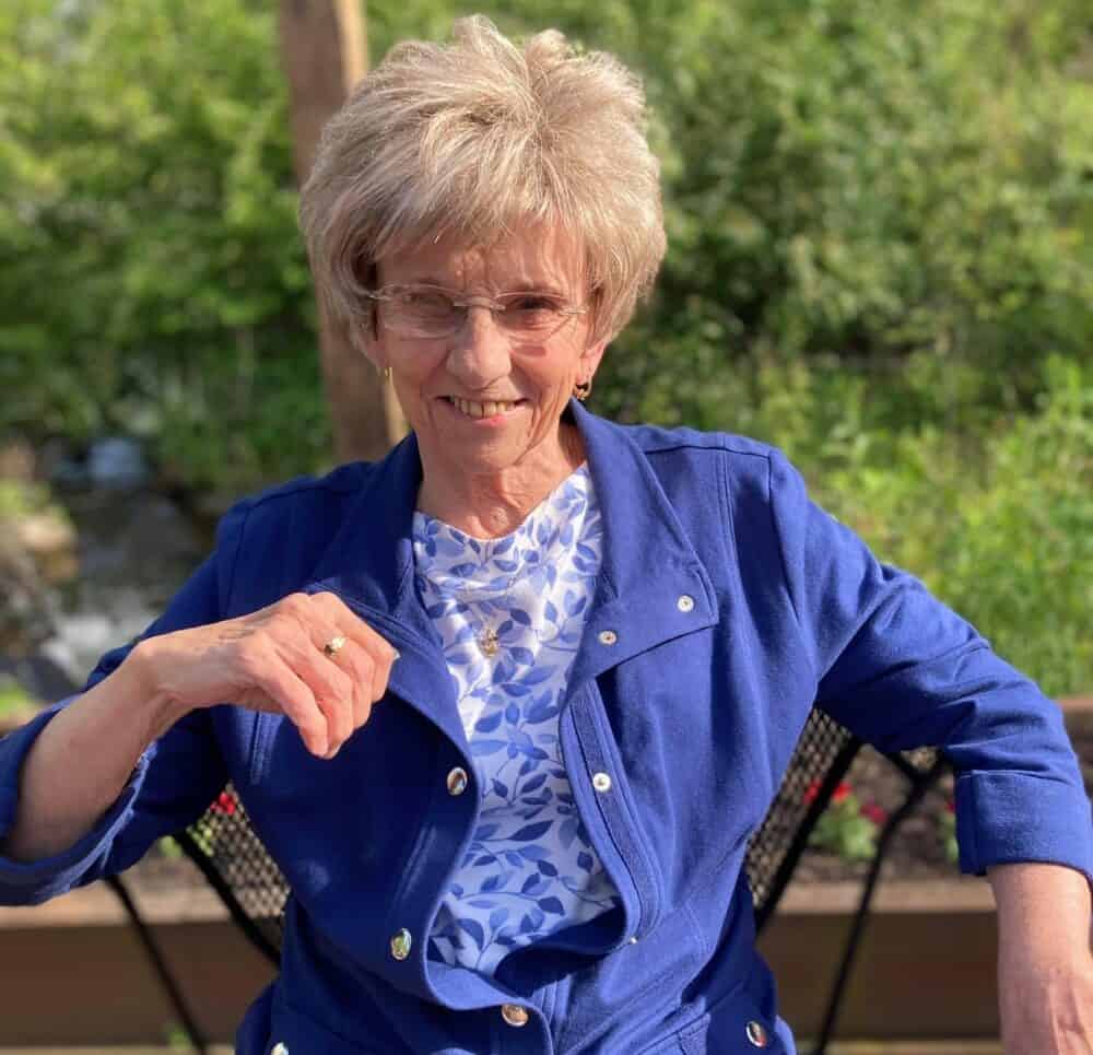 Senior woman smiling outside at a senior living facility in Greenwood, Indiana.