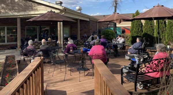 Group of seniors listening to music outside at a senior living facility in Greenwood, Indiana.