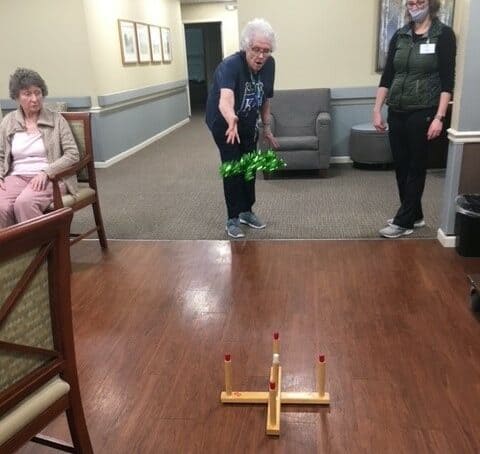 Senior woman plays ring toss at Vintage Gardens, a senior living community in St. Joseph, Missouri.