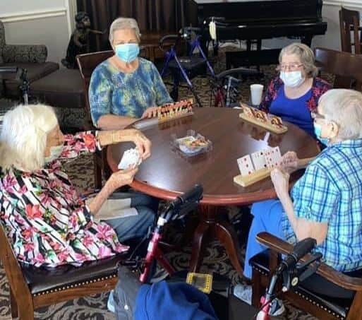Four senior women play Rummy at a senior living community in Stephenville, Texas.
