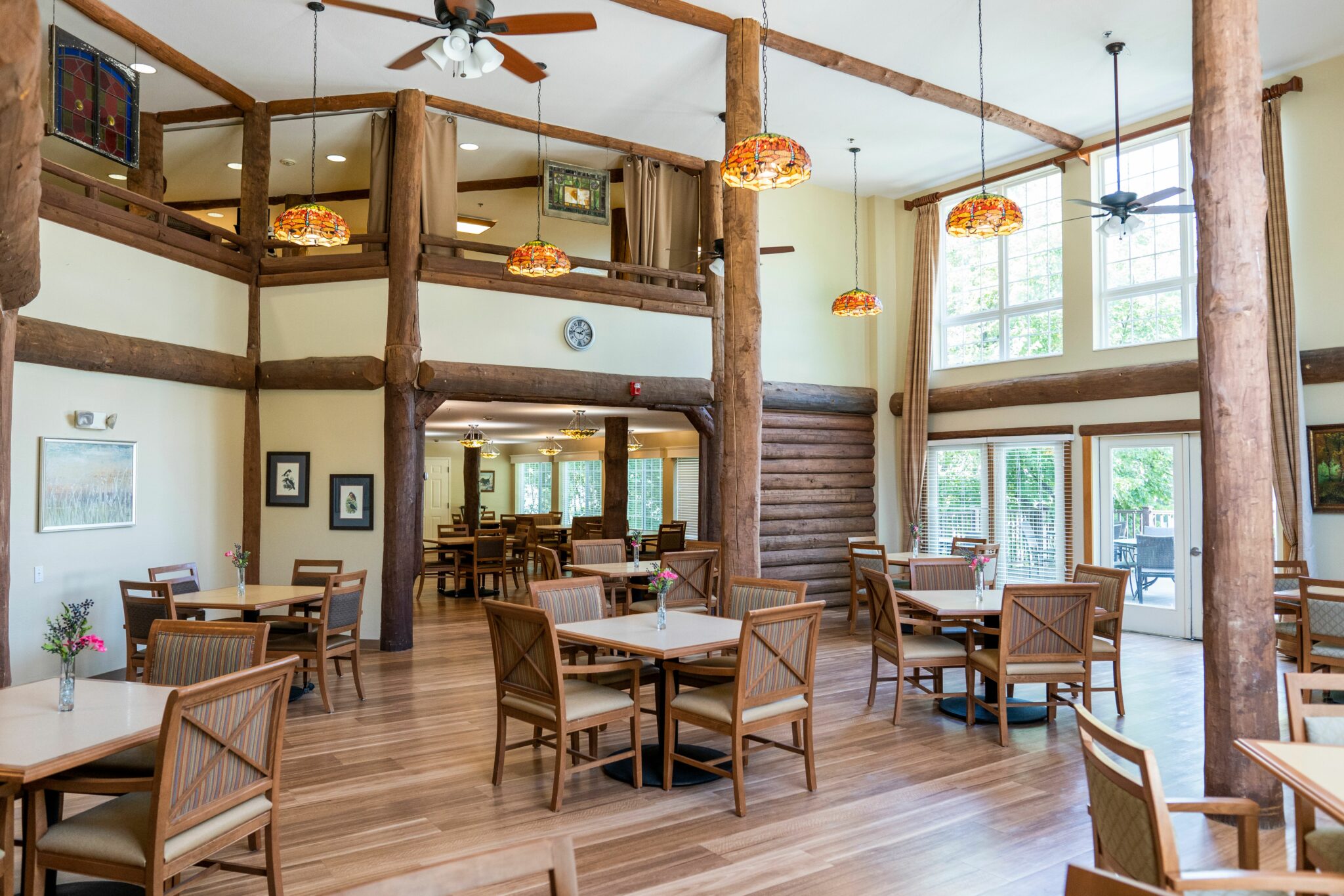 Rose Arbor and Wildflower Lodge dining room with soaring ceiling and wood exposed beams and columns at a senior living facility in Maple Grove, Minnesota