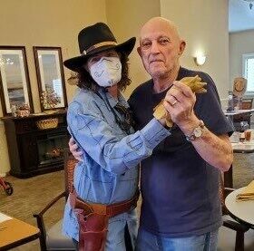 Senior man dances with a senior living employee at a senior living community in Cottonwood, Arizona.