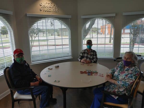 Group of seniors playing a game of cards at a senior living facility in Baytown, Texas.