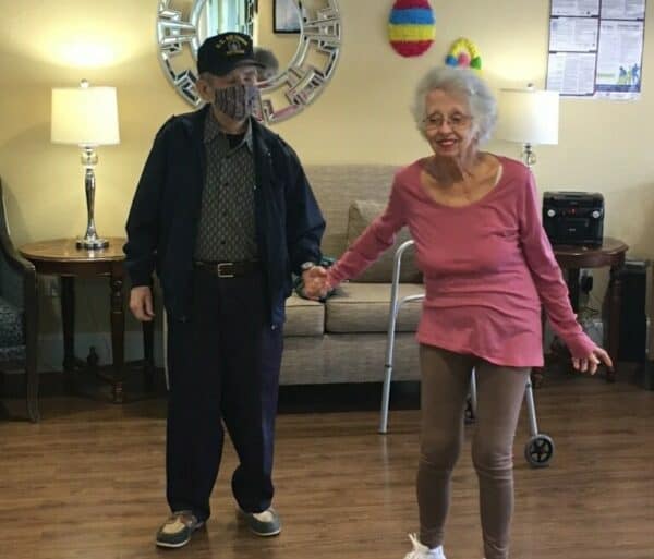 Senior man and woman dance together at a senior living facility in Richardson, Texas.