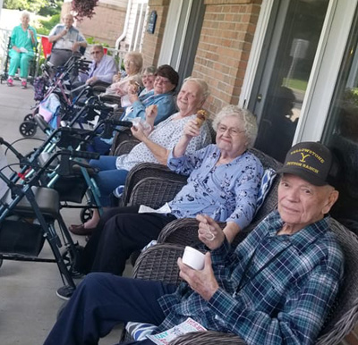 group of seniors eat ice cream treats outside together